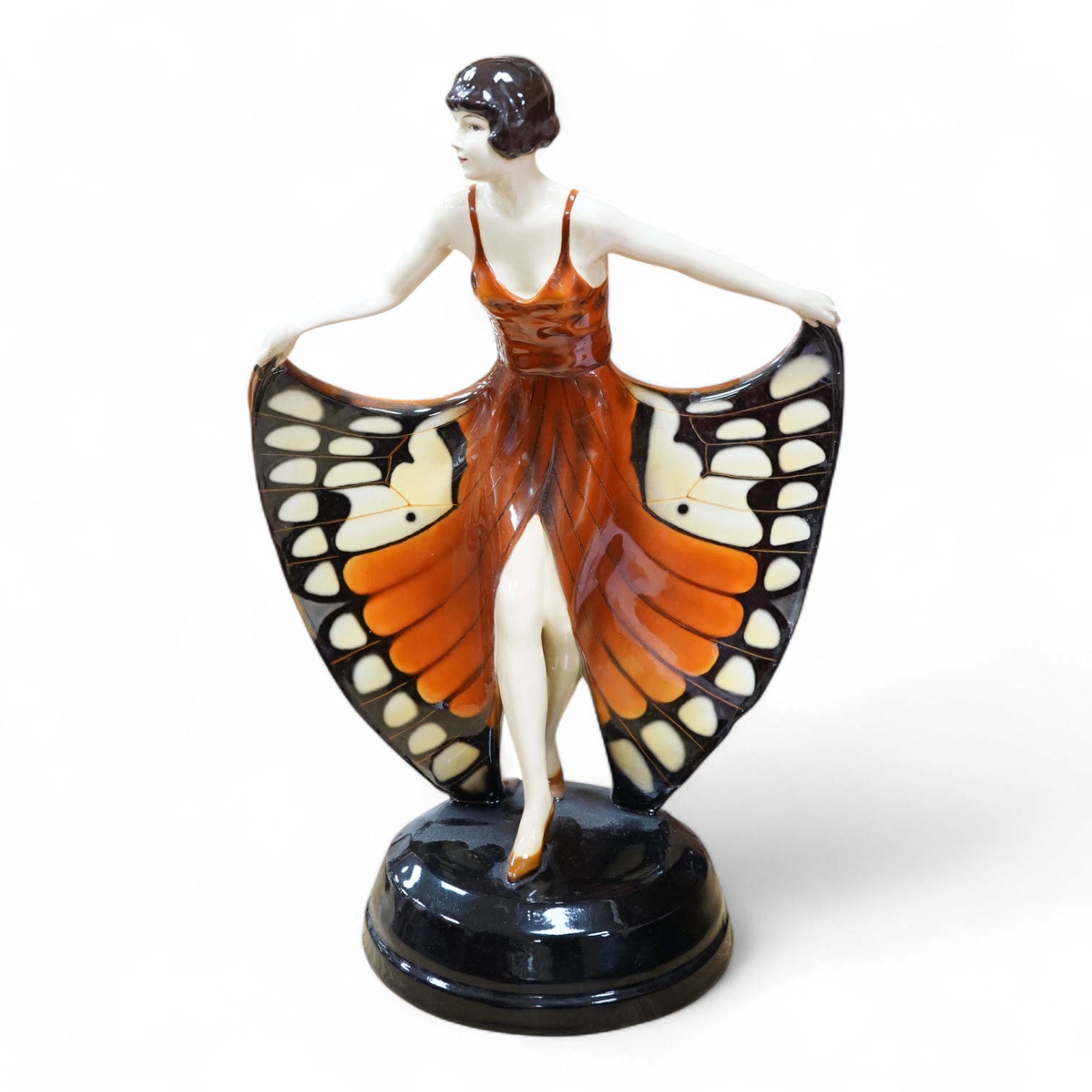 A Lorenzl Goldscheider butterfly dancer figurine, stamped to the base, restored, 42cm high